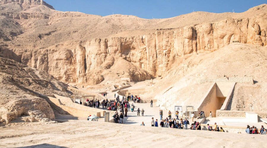 A-wonderful-shot-of-a-group-of-tourists-in-front-of-the-Valley-of-the-Kings-in-Luxor